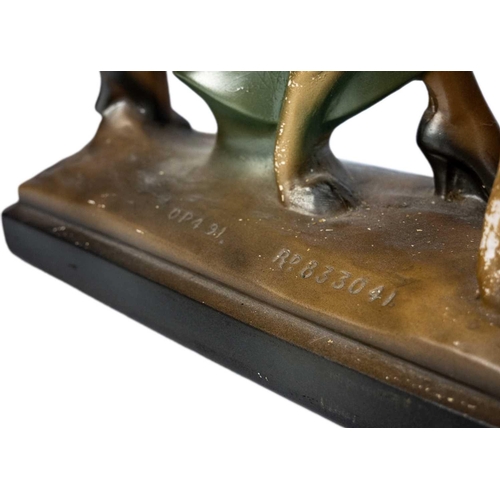 438 - An Art Deco spelter figure of a kneeling lady and greyhound. On a marble base, with an attahed plaqu... 