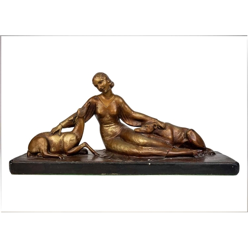 438 - An Art Deco spelter figure of a kneeling lady and greyhound. On a marble base, with an attahed plaqu... 