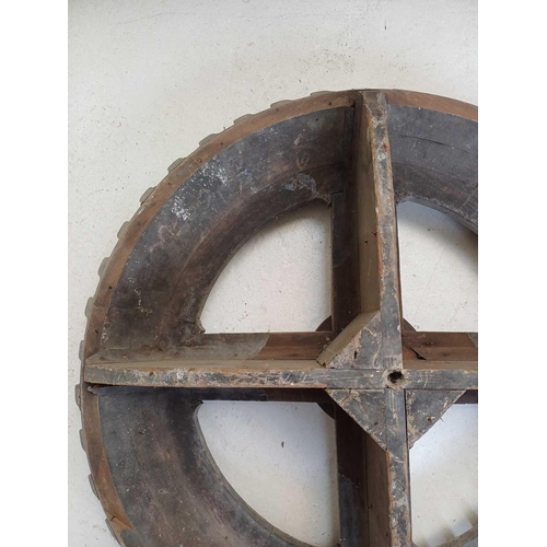 45 - A large gray painted hardwood cog pattern. Diameter 80cm.