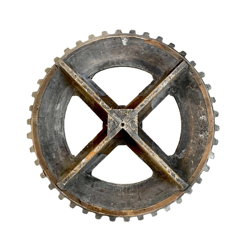 45 - A large gray painted hardwood cog pattern. Diameter 80cm.