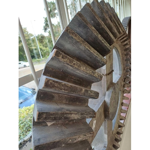 45 - A large gray painted hardwood cog pattern. Diameter 80cm.