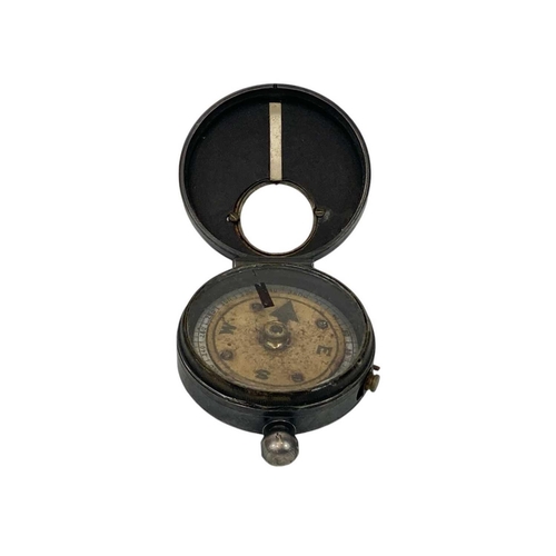 505 - A late 19th century lacquered brass marching compass. With mother of pearl chapter ring and reflecti... 