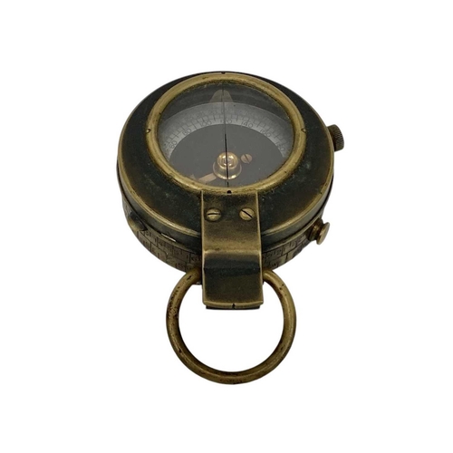 506 - A WWII era lacquered brass MK IX prismatic marching compass. Broad arrow mark and 1943 date to the b... 