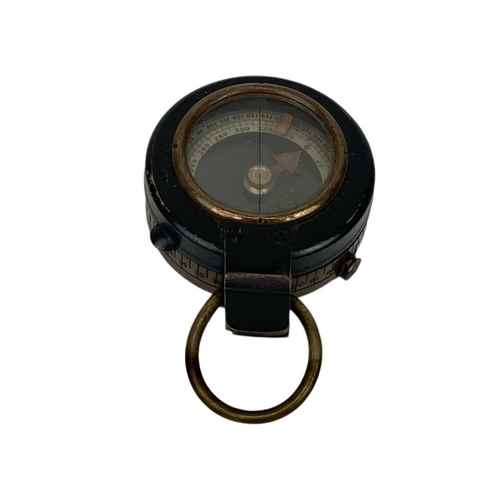 506 - A WWII era lacquered brass MK IX prismatic marching compass. Broad arrow mark and 1943 date to the b... 