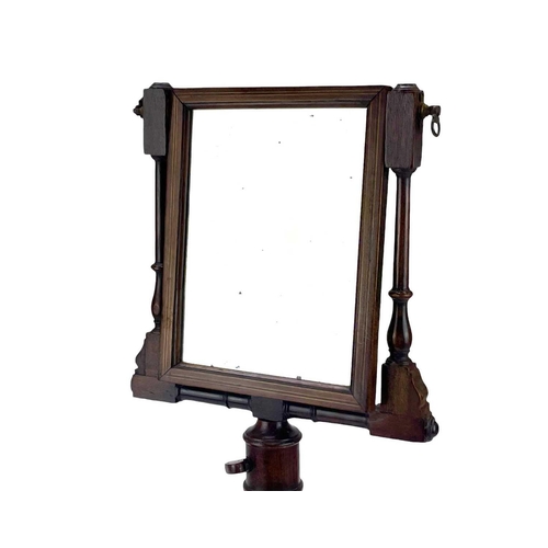 518 - A 19th century mahogany bachelor shaving mirror. With adjustable mirror within a turned frame, heigh... 