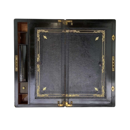 52 - A Victorian brass inlaid mahogany writing box. With a fitted interior and three concealed drawers, h... 