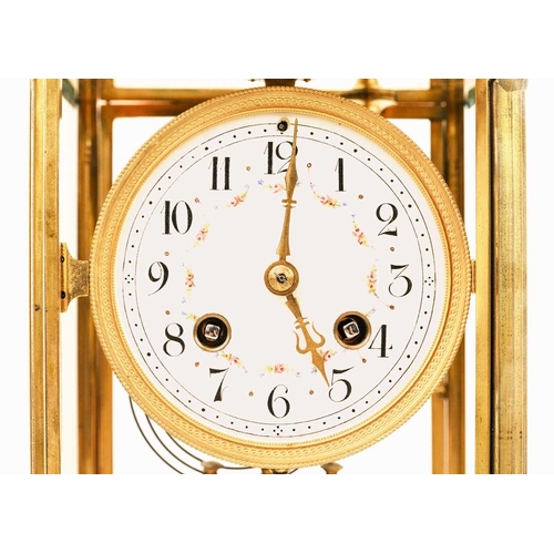 520 - A French four-glass gilt metal mantel clock. Late 19th century, the circular dial with enamelled flo... 