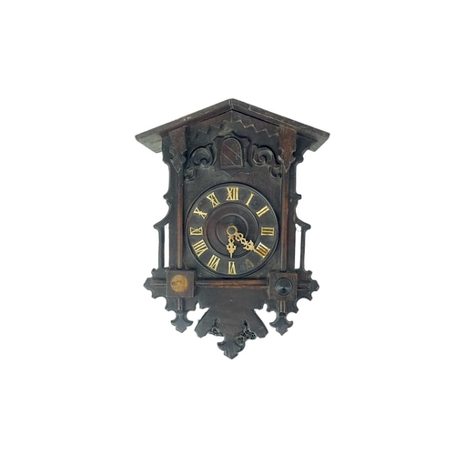 524 - A Black Forest cuckoo wall clock. With pine cone weights, height of case 35cm, together with an Amer... 