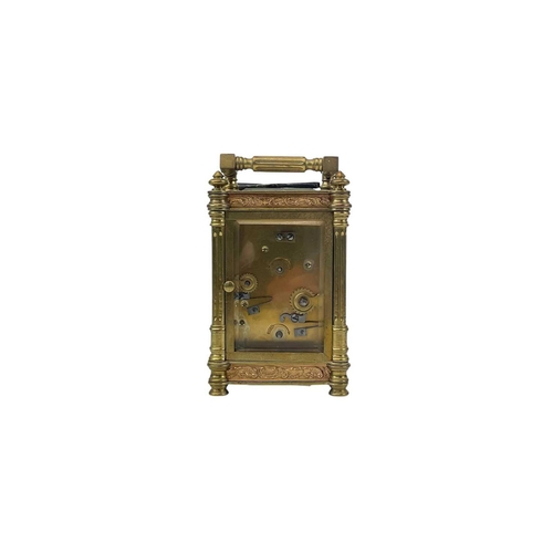 528 - A French carriage alarm clock. Late 19th century, with embossed copper panels, and brass column supp... 