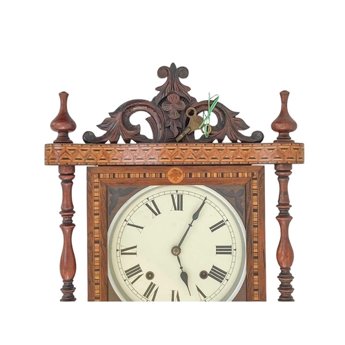 530 - An American ornate rosewood and inlaid wall clock. With a pseudo mercury pendulum, height 92cm.