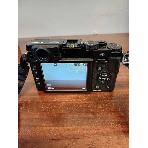 55 - A Fujifilm X20 digital camera. With battery charger and manual. The battery has been charged and the... 