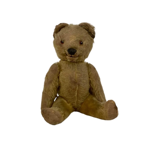 551 - An English plush teddy bear. 1950s, with cantilever button operated opening mouth, length 40cm, play... 