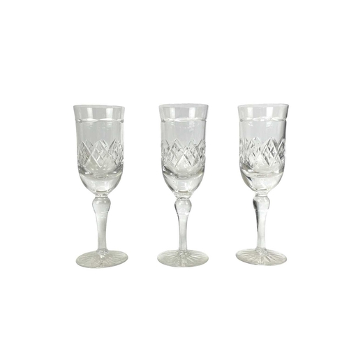 556 - A Tudor Crystal part suite. Comprising: six champagne flutes, six wine, five sherry glasses and two ... 