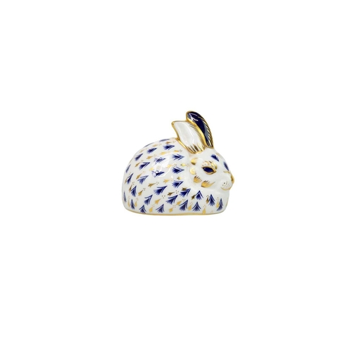 564 - Two Royal Crown Derby rabbit paperweights. With gilt stoppers, together with a Herend group of two d... 