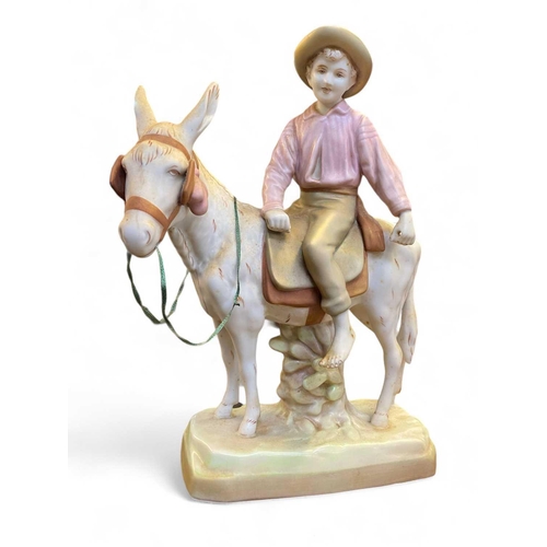 567 - A Royal Dux porcelain figure group of a boy riding a donkey. Height 37.5cm together with a Royal Dux... 