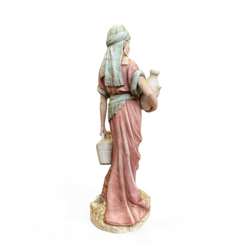 574 - A Royal Dux porcelain figure of a water carrier. Applied pink triangle impress number 1074, height 4... 