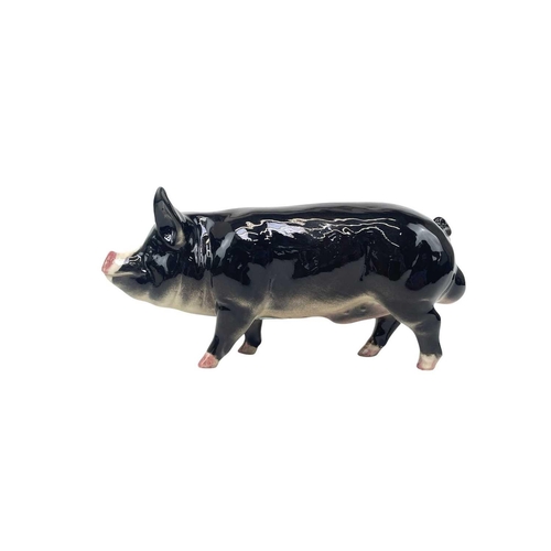 589 - A Beswick Pottery Berkshire boar. In gloss together with a Beswick Pottery Blackface ewe, lamb and a... 