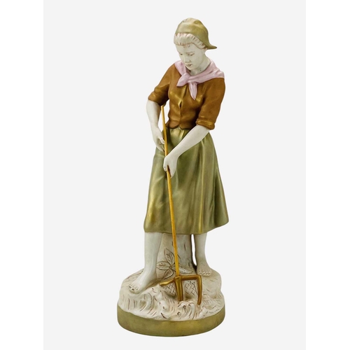 590 - A Royal Dux porcelain figure of a farm girl. Modelled with a pitchfork, height 52cm.