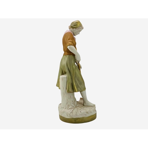 590 - A Royal Dux porcelain figure of a farm girl. Modelled with a pitchfork, height 52cm.