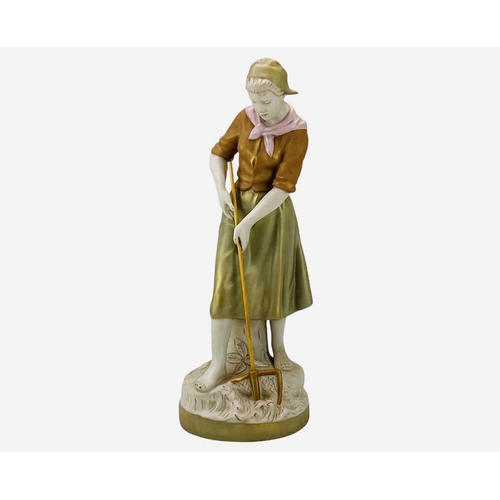 590 - A Royal Dux porcelain figure of a farm girl. Modelled with a pitchfork, height 52cm.