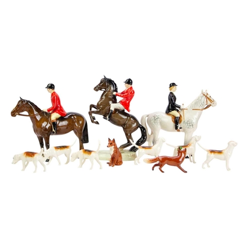 591 - A Beswick Huntsman on a rearing horse. Impressed 686, height 23cm together with a Huntswoman on a da... 