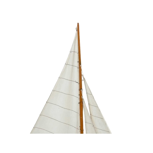 61 - A model of a yacht. Modern, with a blue painted hull, on a painted base, height 110cm.