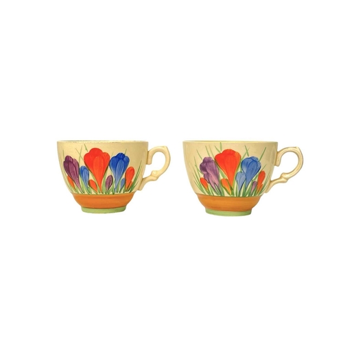 610 - Clarice Cliff Crocus pattern. Comprising: two teacups, two breakfast cups, a mug, an egg cup, four s... 