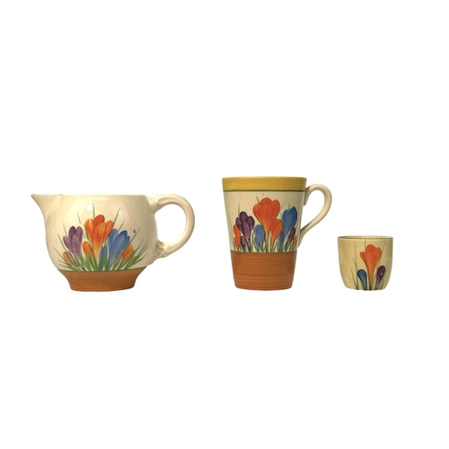 610 - Clarice Cliff Crocus pattern. Comprising: two teacups, two breakfast cups, a mug, an egg cup, four s... 