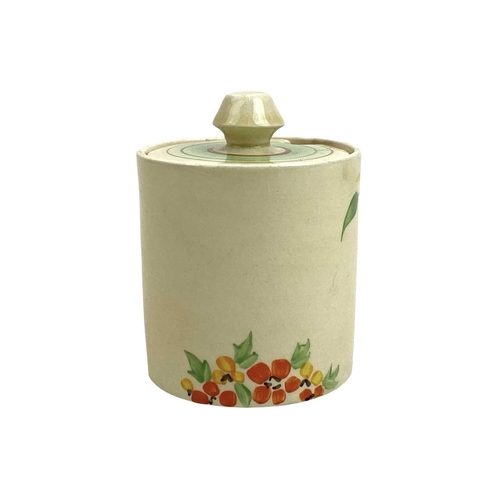 620 - A Wilkinson Ltd drum shape preserve pot and cover with possibly a Clarice Cliff design. Height 9cm.