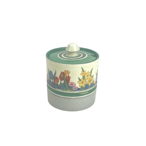 686 - A Clarice Cliff Chloris pattern drum shape preserve pot and cover. Honeyglaze marks, height 9cm toge... 