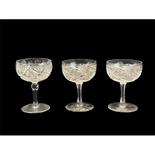 709 - A set of six Edwardian cut glass champagne coupes. Height 11cm, another similar glass, a pair of sma... 