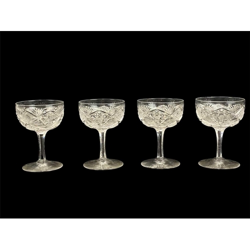 709 - A set of six Edwardian cut glass champagne coupes. Height 11cm, another similar glass, a pair of sma... 