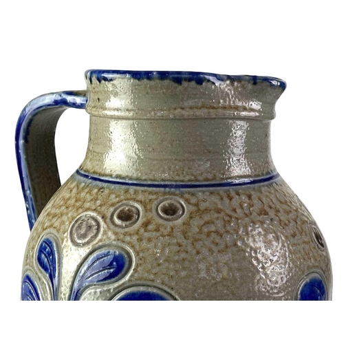 729 - An 18th century brown salt glaze jug. Height 12.5cm, together with a larger and later polychrome sal... 