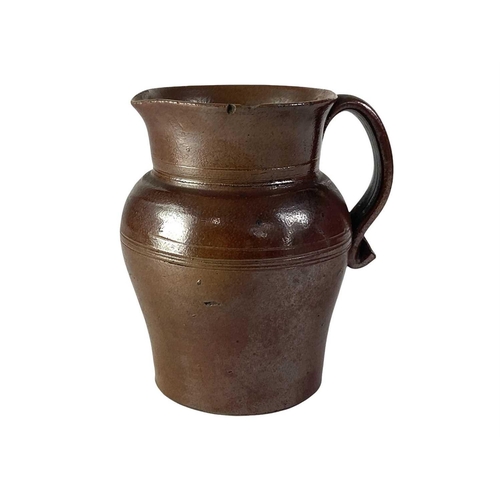 729 - An 18th century brown salt glaze jug. Height 12.5cm, together with a larger and later polychrome sal... 