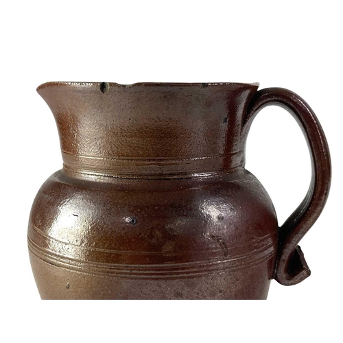 729 - An 18th century brown salt glaze jug. Height 12.5cm, together with a larger and later polychrome sal... 