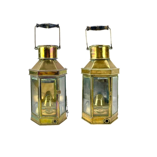 73 - A pair of brass bulkhead oil lamps by Bulpitt & Sons. Height 40cm. (2)