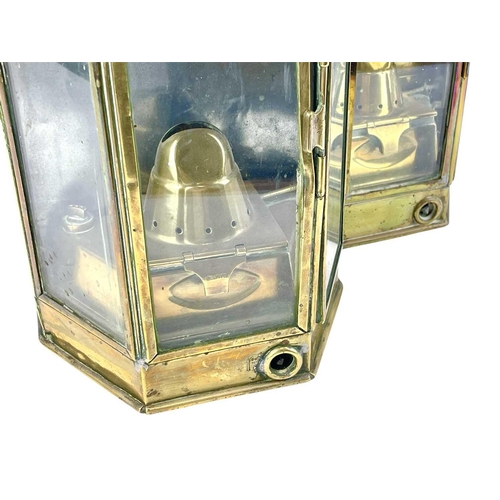 73 - A pair of brass bulkhead oil lamps by Bulpitt & Sons. Height 40cm. (2)