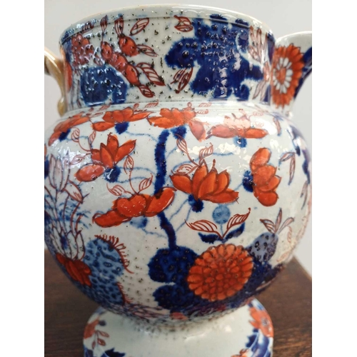 746 - A large 19th century Mason's twin handled stem footed tureen and cover. Decorated in the Imari palet... 