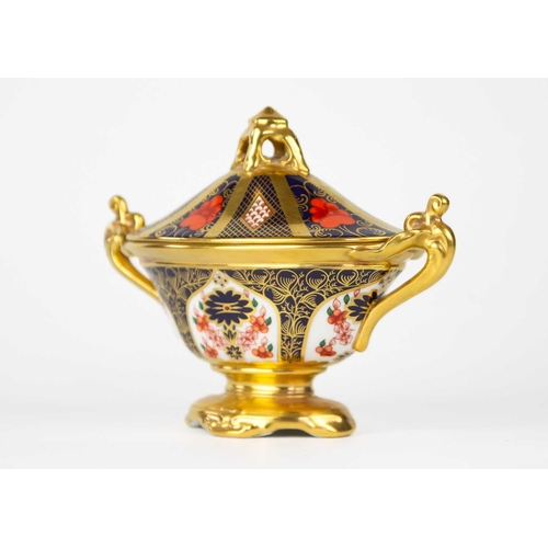 765 - A Royal Crown Derby Imari twin-handled oval navette urn and cover. Pattern no 1128, height 14cm, wid... 