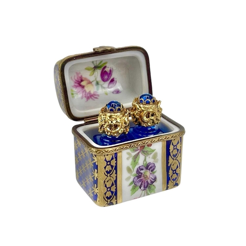 772 - Three Limoges porcelain trinket boxes. Each with painted floral decoration, largest height 6.5cm. (3... 