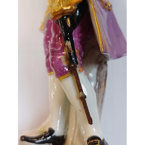 784 - A Meissen figure of a Gallant with a sword.. Late 19th century, in 18th century costume, height 20cm... 