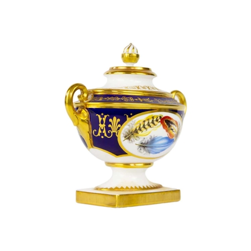 793 - A Royal Worcester Heritage Collection vase and cover. With opposing oval panels painted with feather... 