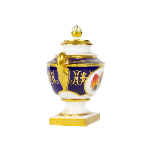 793 - A Royal Worcester Heritage Collection vase and cover. With opposing oval panels painted with feather... 