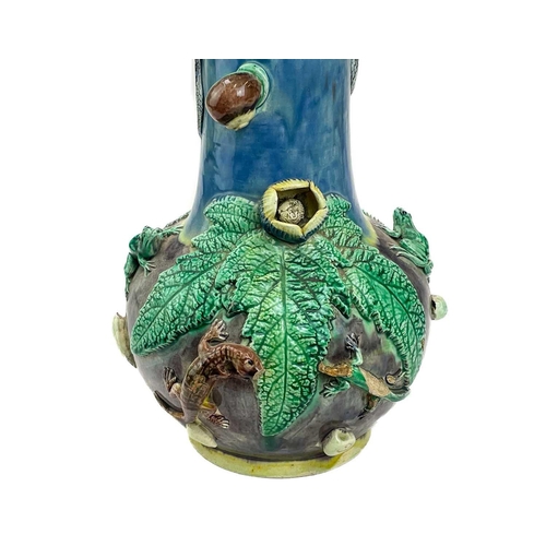 795 - A Portugese Palissy style vase. Circa 1900, with curled snake handles and applied moulded foliage, l... 