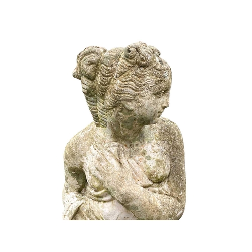 824 - A reconstituted stone emblematic figure of winter. Height 80cm.