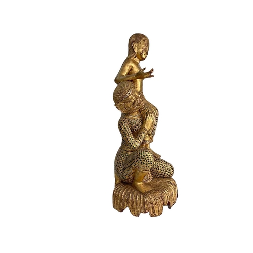 83 - A Burmese lacquered gilt figure group. Height 60cm.