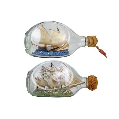 31 - Two bottled ship models A remarkably detailed model ship in a bottle – a three-masted barque with a ... 