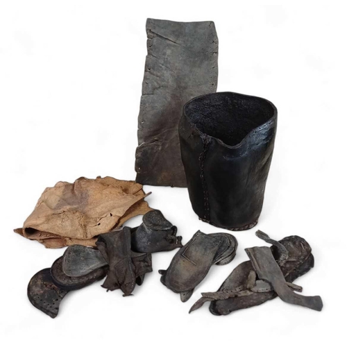 1150 - HMS Invincible A Leather bucket maximum height 24cm and other leather from this historic wreck inclu... 