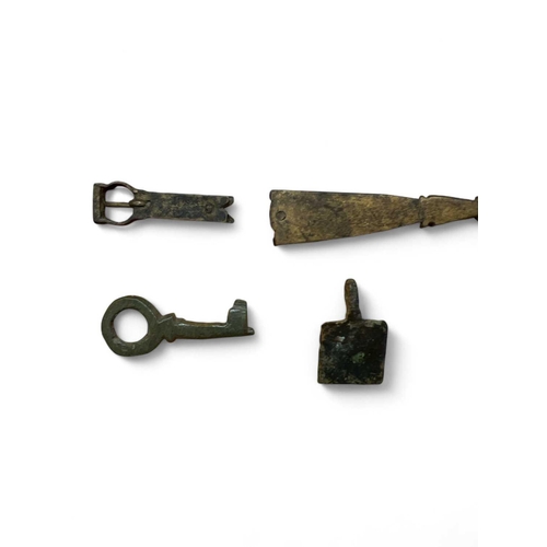 283 - Medieval Bronze A horse harness pendant 15mm wide, a bronze thimble, a key 3.5cm and a strap end and... 