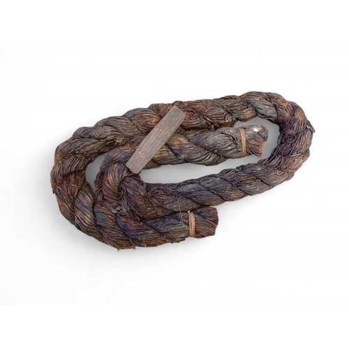 89 - Marie Rose, The Solent, 1545 A coil of tarred rope and wooden wedge Approximately 120cm in length, 5... 